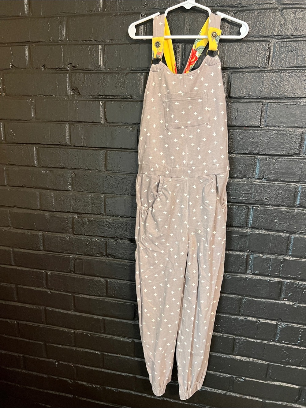 Matilda Jane Taupe One-Piece Overalls with White Cross Print and Yellow Straps